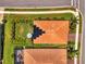 Striking aerial shot of home with lush lawn, perimeter landscaping, and solar panels at 11819 Sistine Ln, Venice, FL 34293