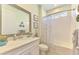 Bathroom with single vanity, white cabinets, and shower-tub combination at 11819 Sistine Ln, Venice, FL 34293