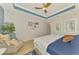 Bright bedroom featuring a ceiling fan, neutral walls, and a comfortable armchair at 11819 Sistine Ln, Venice, FL 34293