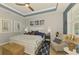 Elegant bedroom with a ceiling fan, tray ceiling, neutral walls, and coastal themed decor at 11819 Sistine Ln, Venice, FL 34293