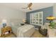 Bedroom with ceiling fan, shutters, and a comfortable armchair at 11819 Sistine Ln, Venice, FL 34293