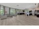 Open and airy common area featuring comfortable seating, a kitchen, and abundant natural light at 11819 Sistine Ln, Venice, FL 34293