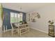 Stylish dining area with farmhouse-style table, bench seating, decorative wall art, and a bright window at 11819 Sistine Ln, Venice, FL 34293