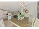 Open concept kitchen and dining area with an island, white cabinets, quartz countertops, and decorative accents at 11819 Sistine Ln, Venice, FL 34293