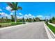 View of a gated entrance with lush green landscaping creating a secure and inviting community at 11819 Sistine Ln, Venice, FL 34293