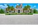 Beautiful clubhouse exterior with stone accents, arched entryways, and lush landscaping at 11819 Sistine Ln, Venice, FL 34293