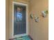 Close up of the front door featuring decorative glass and colorful wall planters at 11819 Sistine Ln, Venice, FL 34293