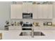 Stylish kitchen with stainless steel appliances, a subway tile backsplash, and ample countertop space at 11819 Sistine Ln, Venice, FL 34293