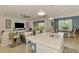 Bright, open-concept kitchen with a quartz-top island and seamlessly connecting to the living and dining areas at 11819 Sistine Ln, Venice, FL 34293