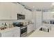 Well-equipped kitchen featuring stainless steel appliances, white cabinetry, and ample counter space at 11819 Sistine Ln, Venice, FL 34293