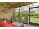 Relaxing screened lanai with comfortable seating and a view of the manicured backyard at 11819 Sistine Ln, Venice, FL 34293