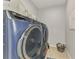 Well-lit laundry room featuring a new washer and dryer with ample space for sorting and folding at 11819 Sistine Ln, Venice, FL 34293