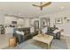 Spacious living room with open layout showcasing comfortable sofas and seamless flow into the kitchen at 11819 Sistine Ln, Venice, FL 34293