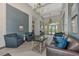Spacious lobby with elegant seating, chandelier, and ample natural light at 11819 Sistine Ln, Venice, FL 34293