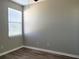 Bedroom with wood-look floors and window with light-filtering blinds at 1271 Jonah Dr, North Port, FL 34289