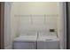 Laundry room featuring washer, dryer, and wire shelving for ample storage at 1271 Jonah Dr, North Port, FL 34289