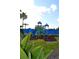 Colorful playground with slides and climbing structures, surrounded by vibrant green landscaping at 1271 Jonah Dr, North Port, FL 34289