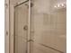 Walk-in shower with glass doors, tile surround, and chrome shower head at 1271 Jonah Dr, North Port, FL 34289