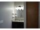 Bathroom features a granite countertop, sleek fixtures, and floating shelves at 1480 Wise Dr, North Port, FL 34286