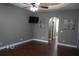Comfortable bedroom featuring hardwood floors, neutral paint, and a wall-mounted television at 1480 Wise Dr, North Port, FL 34286