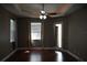 A primary bedroom with a ceiling fan and hardwood floors, offering a tranquil retreat at 1480 Wise Dr, North Port, FL 34286