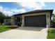 Beautiful one-story house featuring a gray stucco exterior, a driveway, and an attached garage at 1480 Wise Dr, North Port, FL 34286