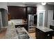 Modern kitchen with stainless steel appliances, granite countertops, and a pantry door at 1480 Wise Dr, North Port, FL 34286