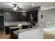 Open-concept kitchen featuring granite countertops, dark wood cabinetry, and stylish pendant lighting at 1480 Wise Dr, North Port, FL 34286