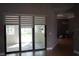 Spacious living room with sliding glass doors, tile flooring, and neutral wall colors at 1480 Wise Dr, North Port, FL 34286