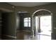 Living room featuring tile floors, arched doorways, and natural light at 1480 Wise Dr, North Port, FL 34286