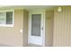 Exterior entrance showing the unit number and beige siding, adjacent to window at 150 Harborside Ave # 124, Punta Gorda, FL 33950