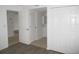 Hallway with tiled floor leads to bathroom and closets with white doors and neutral paint at 150 Harborside Ave # 124, Punta Gorda, FL 33950