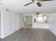 Open living space flows into the kitchen with wood flooring and neutral paint at 150 Harborside Ave # 124, Punta Gorda, FL 33950