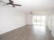 Spacious, brightly lit living room features ceiling fans and sliding glass doors to outdoor patio at 150 Harborside Ave # 124, Punta Gorda, FL 33950