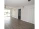 Open-concept living room features wood flooring, neutral walls, a sliding glass door, and closets at 150 Harborside Ave # 124, Punta Gorda, FL 33950