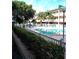 Inviting community pool featuring clear blue water, lounge chairs, and mature landscaping at 150 Harborside Ave # 124, Punta Gorda, FL 33950