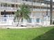 Community pool area with white picket fence and lounge chairs, perfect for relaxation and enjoying the outdoors at 150 Harborside Ave # 124, Punta Gorda, FL 33950