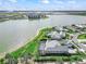 Aerial view of a beautiful home with a pool, lake views, and lush landscaping at 17213 Bullhorn Cir, Punta Gorda, FL 33982