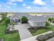 Stunning lakefront home featuring a spacious layout, elegant gray exterior, and lush landscaping at 17213 Bullhorn Cir, Punta Gorda, FL 33982