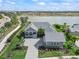 Beautiful home situated by a lake, showcasing well-manicured lawns and a paved driveway at 17213 Bullhorn Cir, Punta Gorda, FL 33982