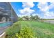 Lush backyard with well-manicured lawn and fence with lake views at 17213 Bullhorn Cir, Punta Gorda, FL 33982