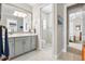 Bright bathroom featuring dual sinks, a glass shower, and white cabinetry providing lots of storage at 17213 Bullhorn Cir, Punta Gorda, FL 33982