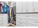 Custom closet with an abundance of storage with hanging rods, shelves, drawers and upper cabinets at 17213 Bullhorn Cir, Punta Gorda, FL 33982