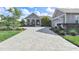Charming home featuring a meticulously paved driveway and inviting front porch with elegant white columns at 17213 Bullhorn Cir, Punta Gorda, FL 33982