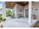 Comfortable front porch with charming seating, a ceiling fan, and a warm, inviting atmosphere at 17213 Bullhorn Cir, Punta Gorda, FL 33982
