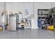 Detailed garage space with battery storage, charging cables, and wall-mounted organizers providing a tidy solution for various equipment at 17213 Bullhorn Cir, Punta Gorda, FL 33982