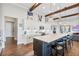 Modern kitchen featuring a large island with seating, white cabinetry, and stylish lighting fixtures at 17213 Bullhorn Cir, Punta Gorda, FL 33982