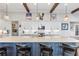 Open concept kitchen with quartz island, stainless appliances, white cabinets, and elegant lighting at 17213 Bullhorn Cir, Punta Gorda, FL 33982
