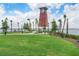 Community lighthouse on the water with lush green lawn and surrounding walkways at 17213 Bullhorn Cir, Punta Gorda, FL 33982