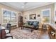 Well-lit living room with black leather sofa, wooden desk, and a patterned rug at 17213 Bullhorn Cir, Punta Gorda, FL 33982